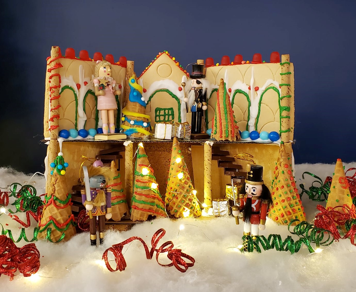 Two story gingerbread house with stairs made of KitKats and nutcracker figures