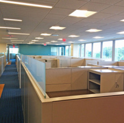 Cubicles with acrylic dividers along the central walkway