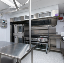 Commercial gas range with vent hood and ovens