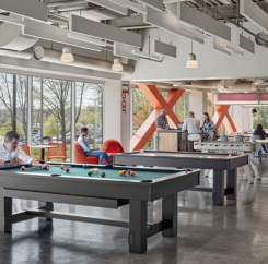 Cafeteria and game room. A man plays pool