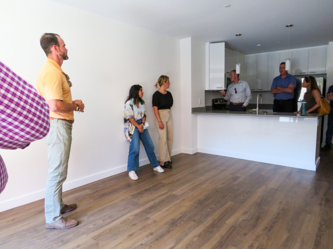 Jason shows the group inside a 1 bedroom unit